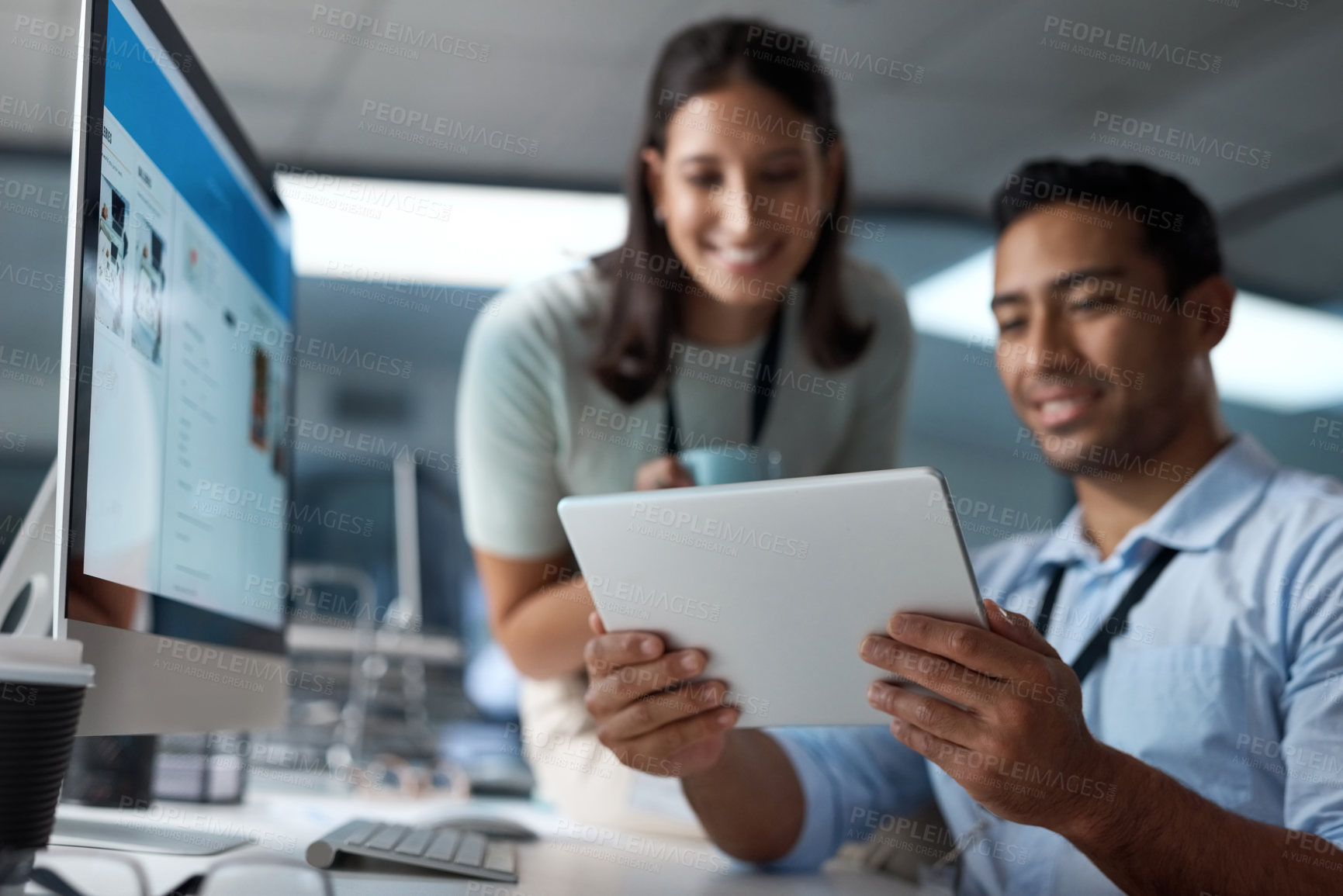 Buy stock photo Shot of a young businessman and businesswoman using a digital tablet in a modern office