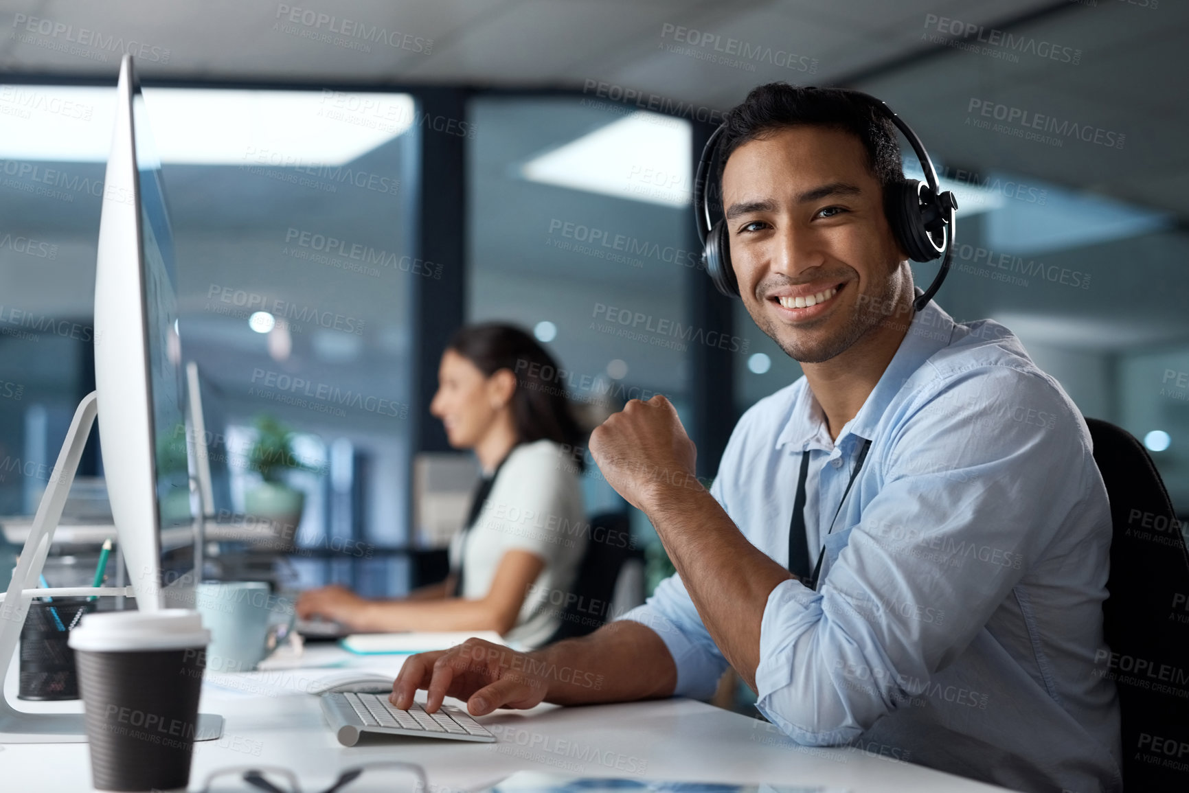 Buy stock photo Portrait of a young man using a headset and computer in a modern office