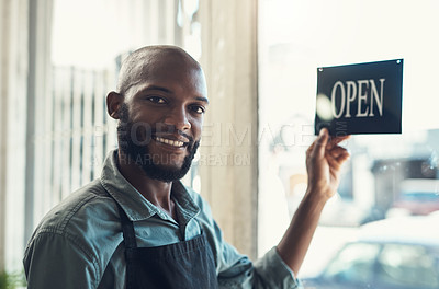Buy stock photo Shot of a handsome young man standing and turning the sign on the door to his bicycle shop
