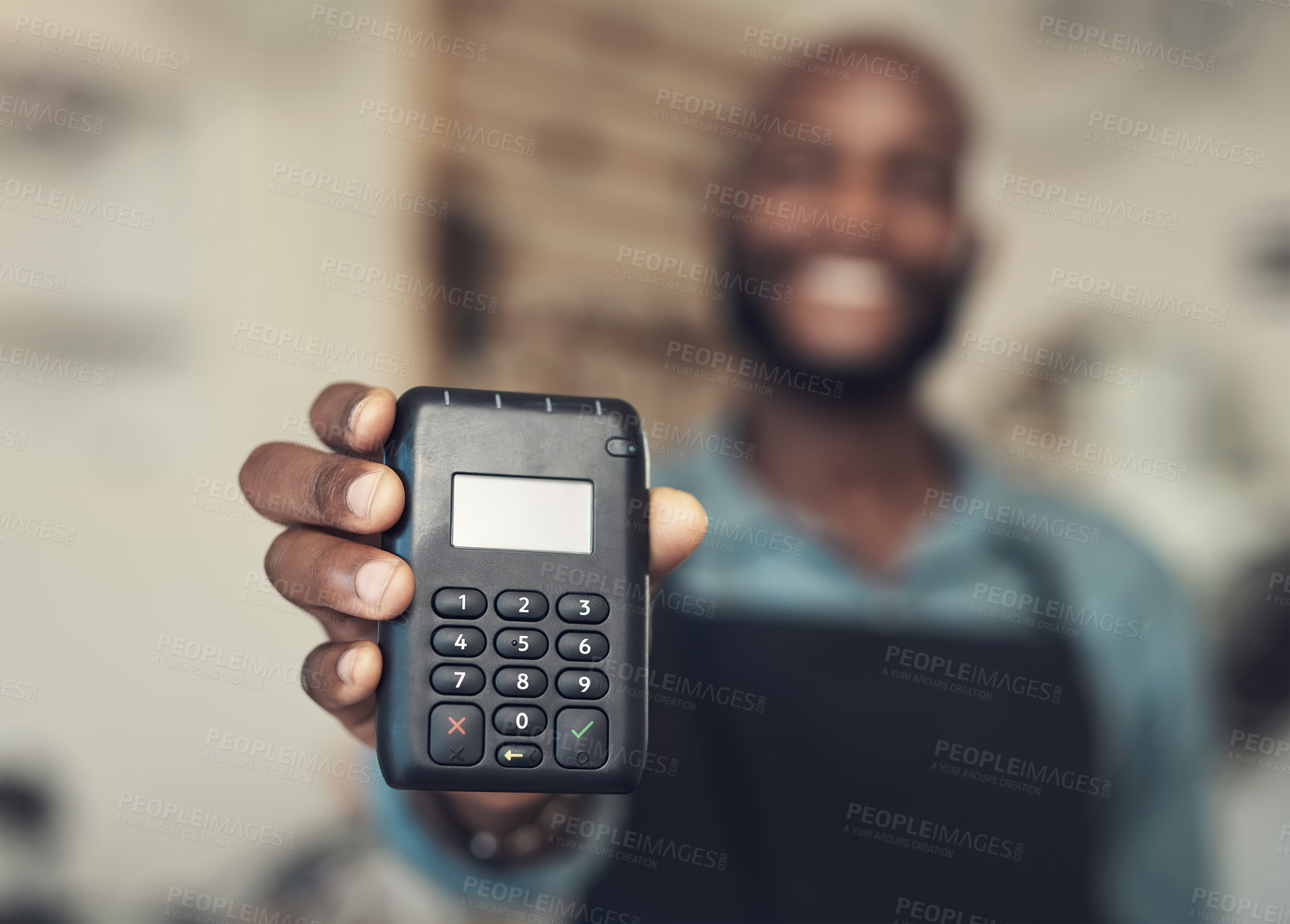 Buy stock photo Shot of an unrecognizable man standing in his bicycle shop and holding a card machine