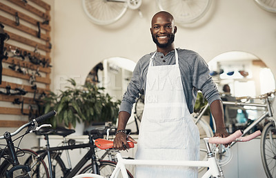 Buy stock photo Portrait of a proud business owner standing in his bicycle repair shop