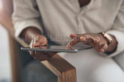 Buy stock photo Shot of a businesswoman using her digital tablet at work