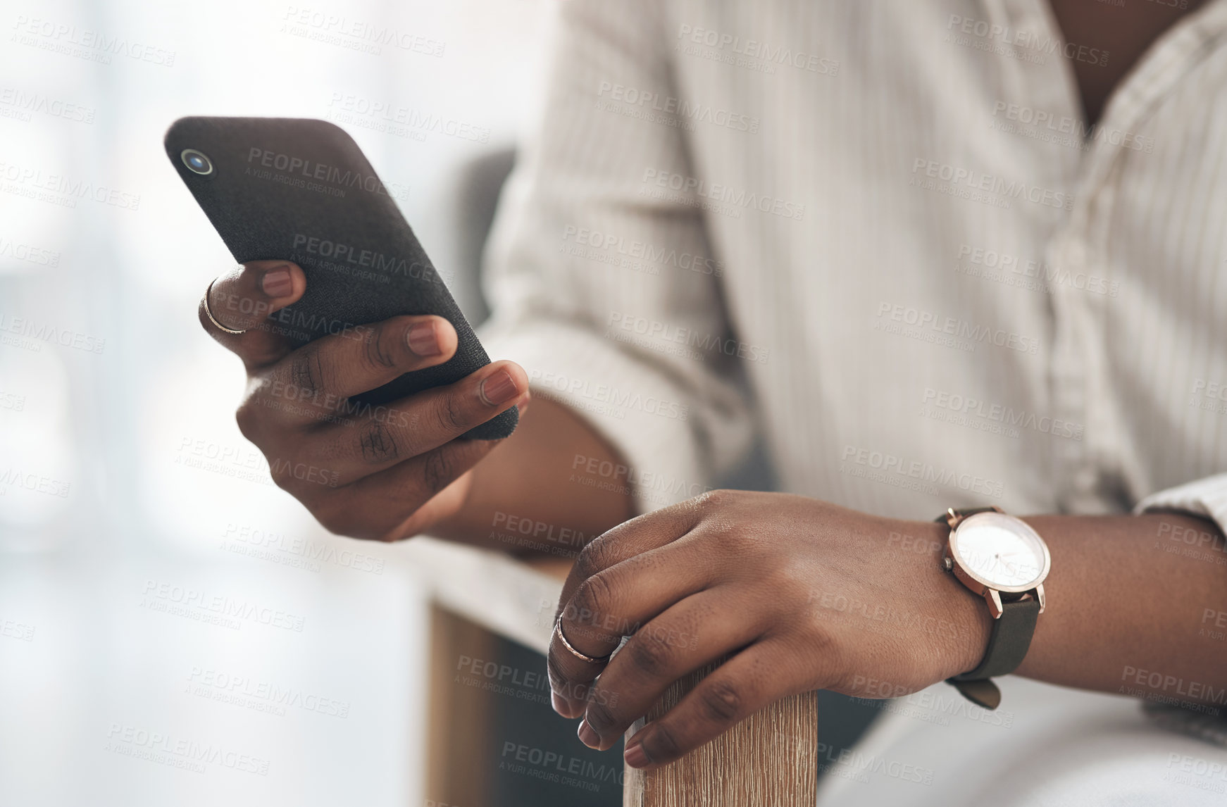 Buy stock photo Shot of a businesswoman using her smartphone to send text messages