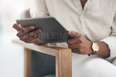 Buy stock photo Shot of a businesswoman using her digital tablet at work