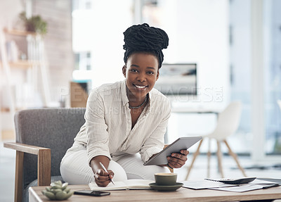 Buy stock photo Shot of a businesswoman using her digital tablet while writing notes