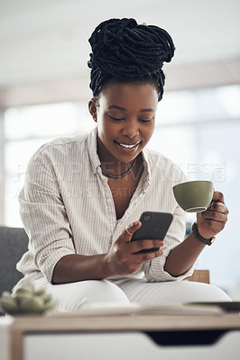 Buy stock photo Shot of a businesswoman using her smartphone to send text messages while drinking coffee