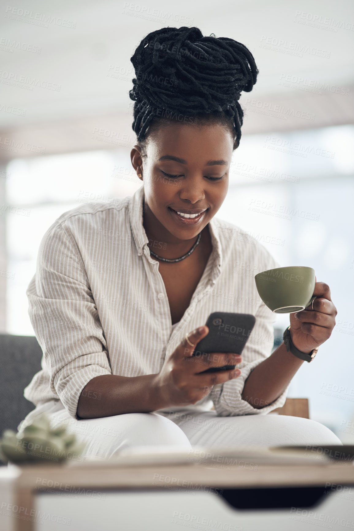 Buy stock photo Shot of a businesswoman using her smartphone to send text messages while drinking coffee