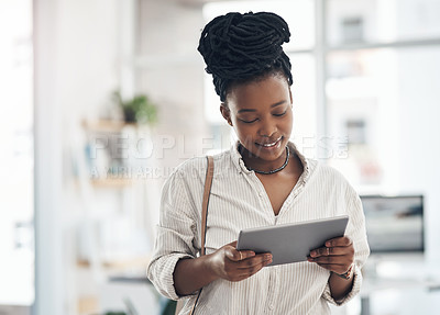 Buy stock photo Shot of a businesswoman using her digital tablet at work