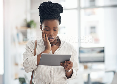 Buy stock photo Shot of a businesswoman using her digital tablet at work