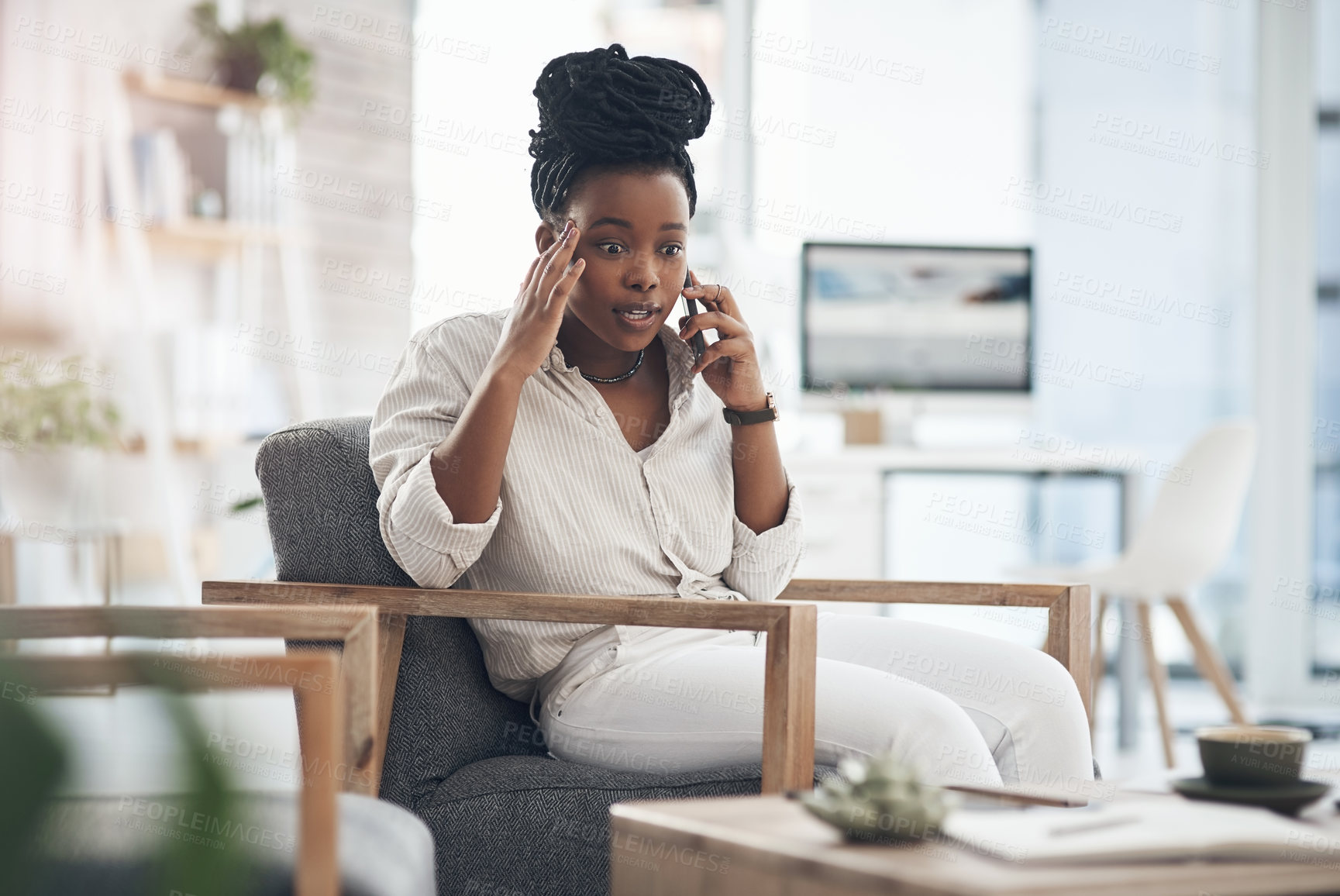 Buy stock photo Shot of a young businesswoman using her smartphone to make phone calls at the office