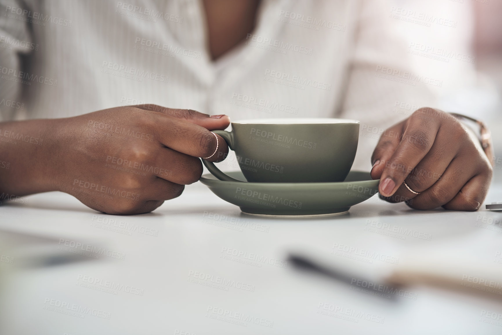 Buy stock photo Shot of a businesswoman enjoying a cup of coffee at work