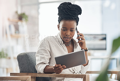 Buy stock photo Shot of a businesswoman using her digital tablet at work while making a call on her smartphone