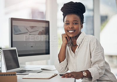 Buy stock photo Shot of a young businesswoman at her office desk