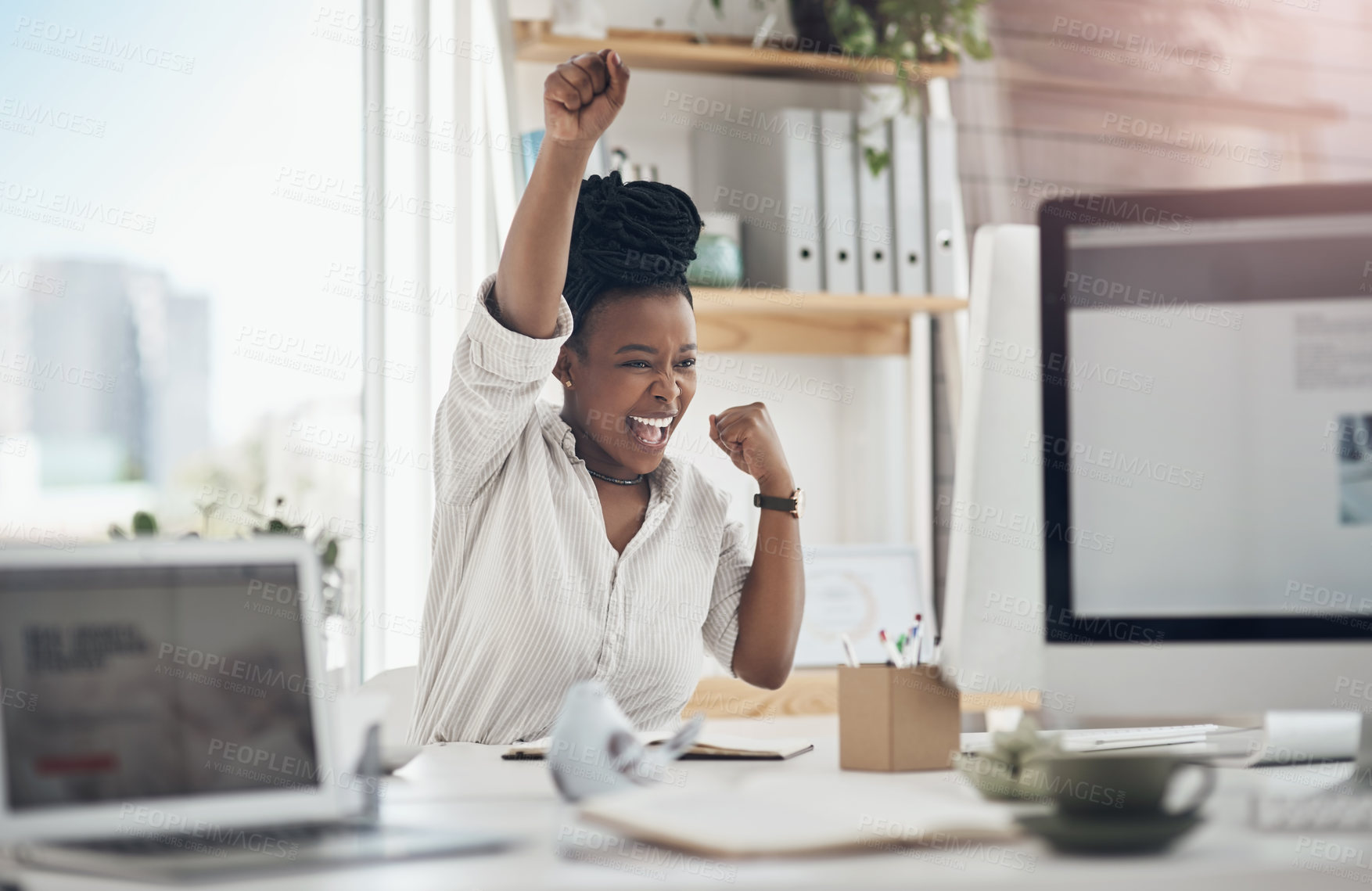 Buy stock photo Shot of a young business celebrating by cheering in her office