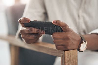 Buy stock photo Shot of a businesswoman using her smartphone to send text messages