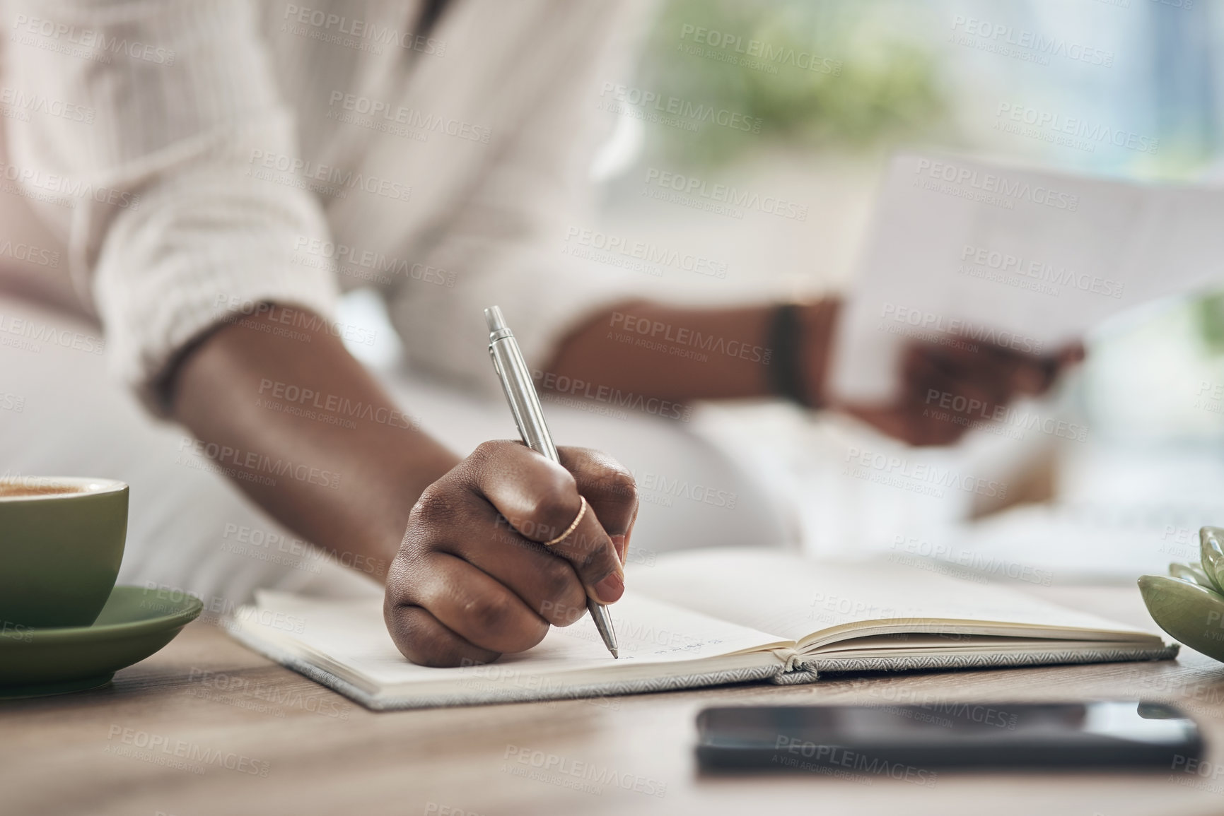 Buy stock photo Shot of a businesswoman writing in her notebook