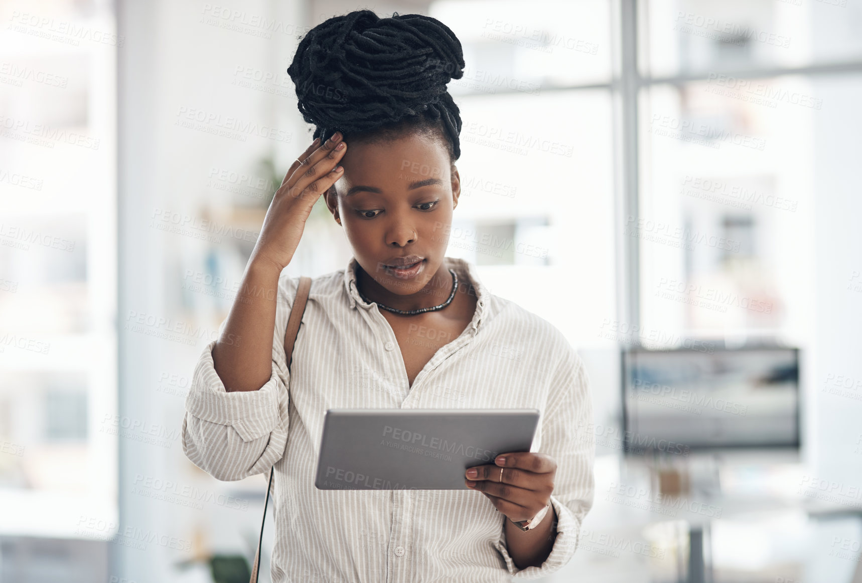 Buy stock photo Shot of a businesswoman using her digital tablet at work