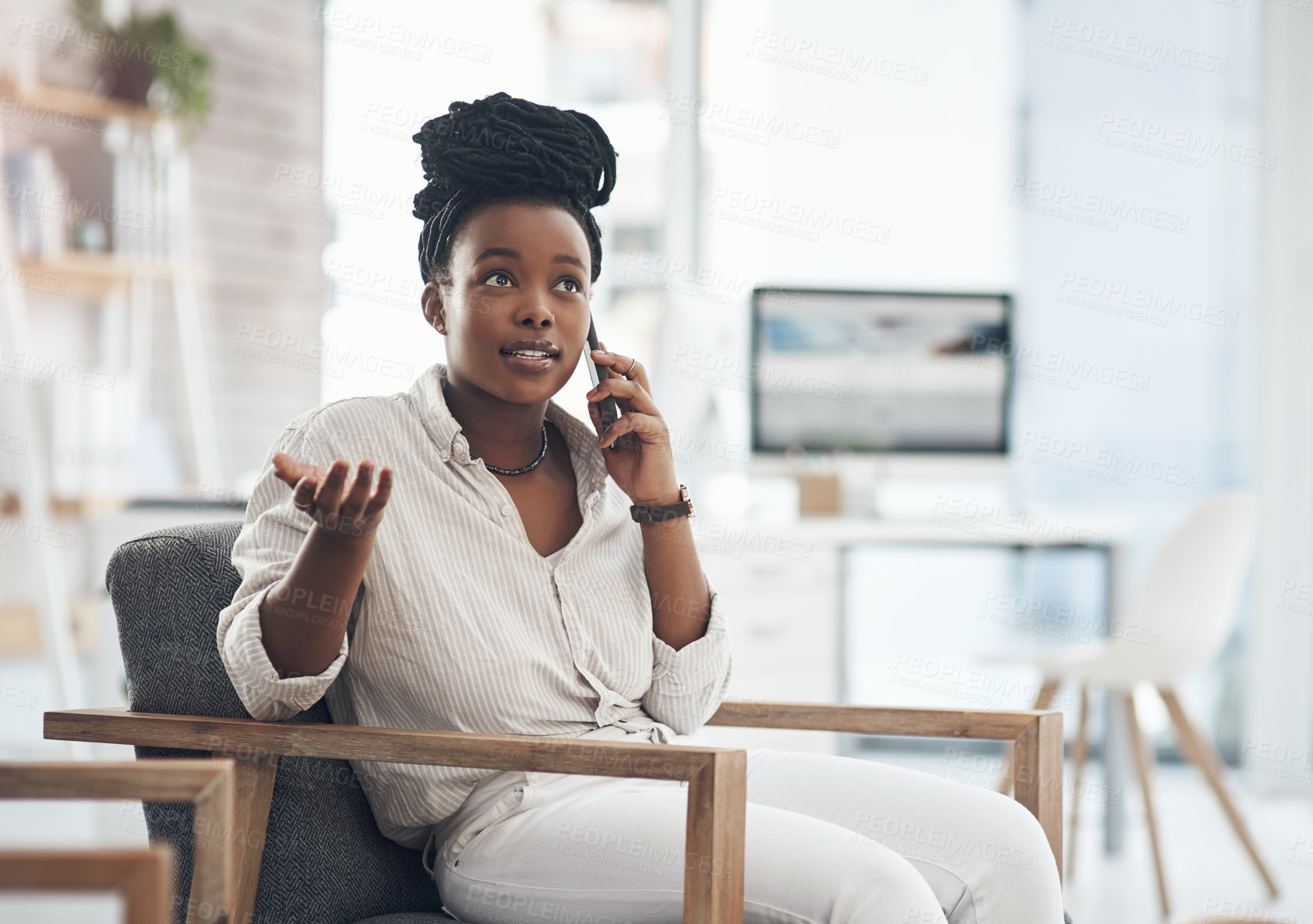 Buy stock photo Shot of a young businesswoman using her smartphone to make phone calls at the office