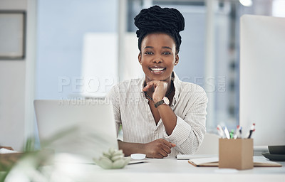 Buy stock photo Shot of a young businesswoman working at her desk in her office