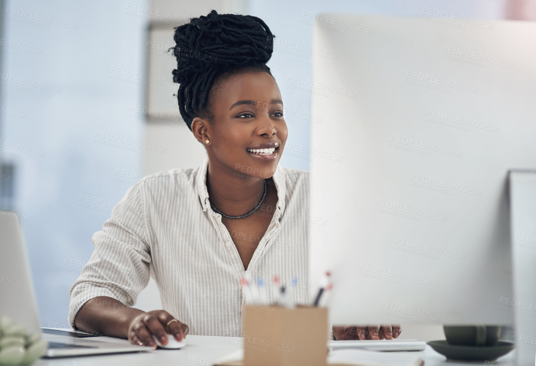 Buy stock photo Shot of a young businesswoman working at her desk in her office