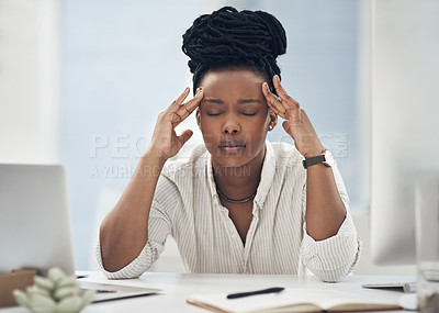 Buy stock photo Shot of a young businesswoman experiencing a headache while at work