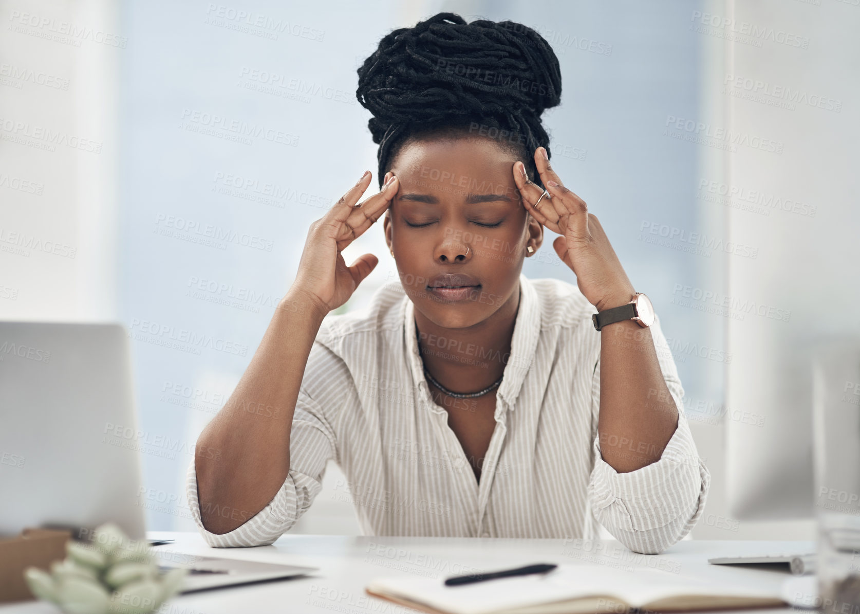 Buy stock photo Shot of a young businesswoman experiencing a headache while at work