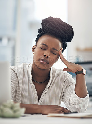 Buy stock photo Shot of a young businesswoman experiencing a headache while at work