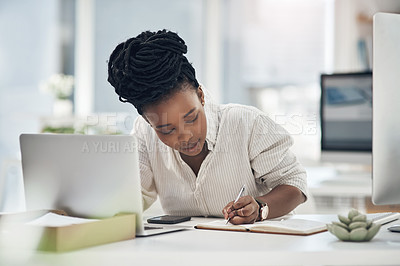 Buy stock photo Shot of a businesswoman writing in her notebook