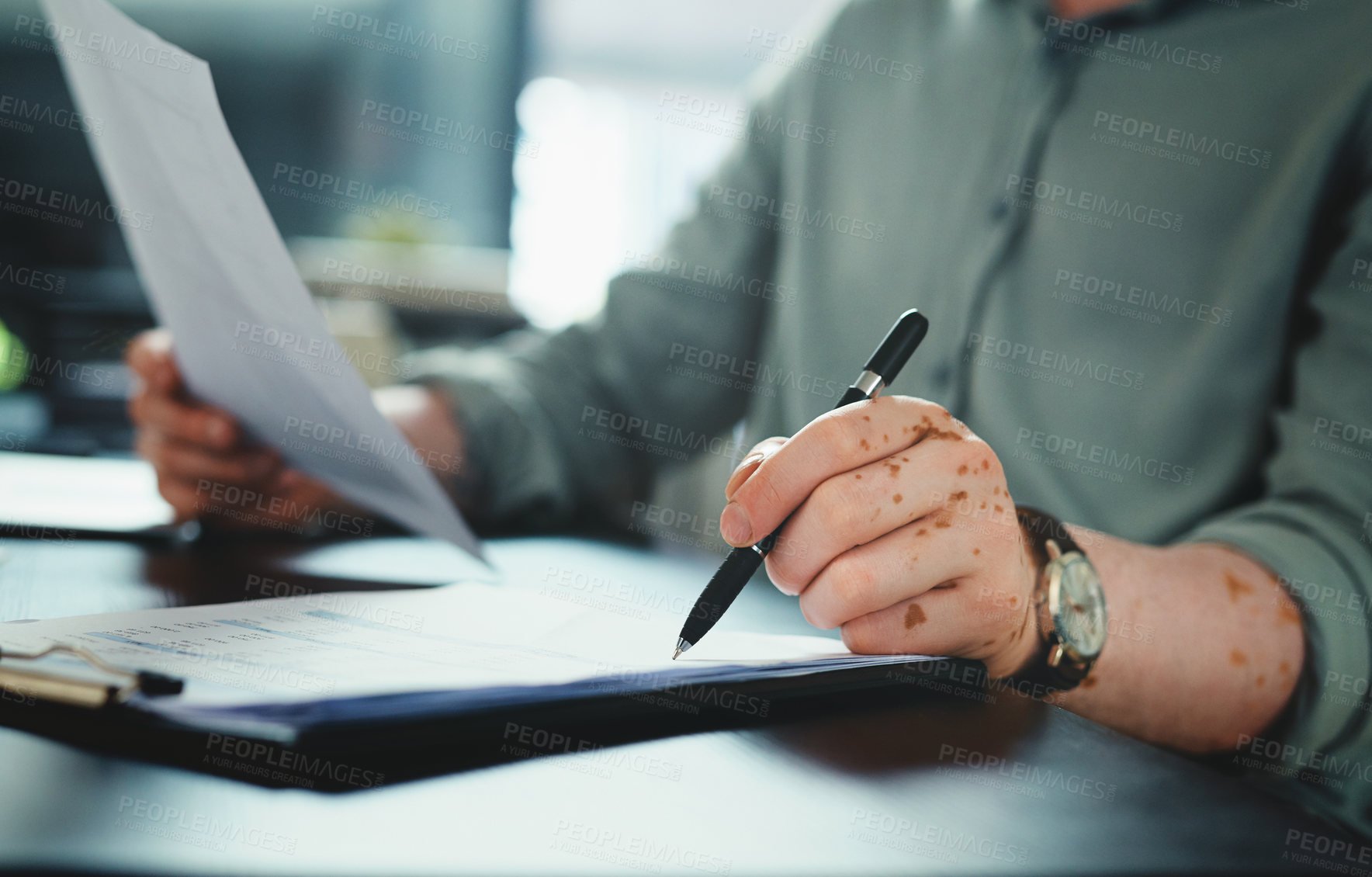 Buy stock photo Shot of an unrecognizable businessman doing paperwork in an office at work