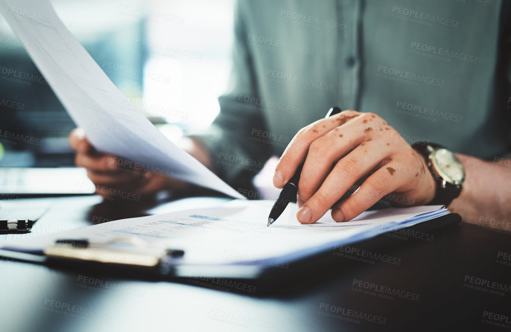 Buy stock photo Shot of an unrecognizazble businessman doing paperwork in an office at work