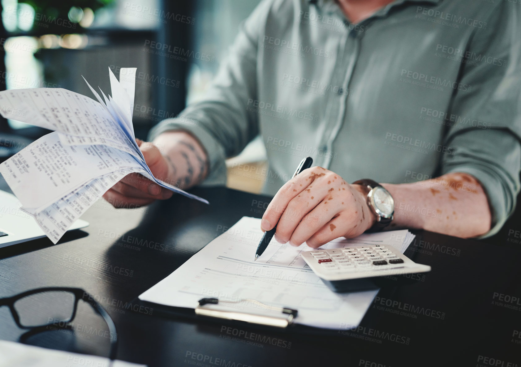 Buy stock photo Shot of an unrecognizazble businessman doing paperwork in an office at work