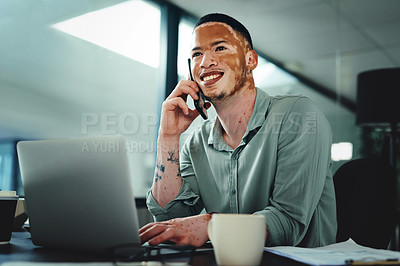 Buy stock photo Shot of a young businessman on a call while using a laptop in an office