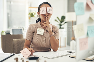 Buy stock photo Shot of a young businesswoman covered in sticky notes and holding her fingers on her lips while working on taxes in an office