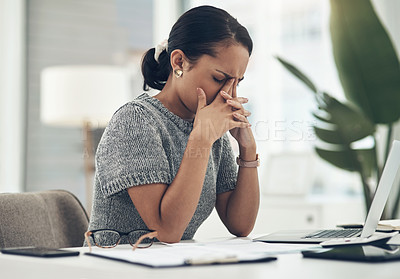 Buy stock photo Shot of a young businesswoman looking stressed out while working in an office