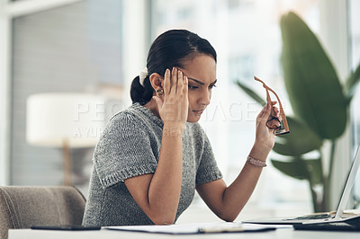 Buy stock photo Shot of a young businesswoman looking stressed out while working in an office