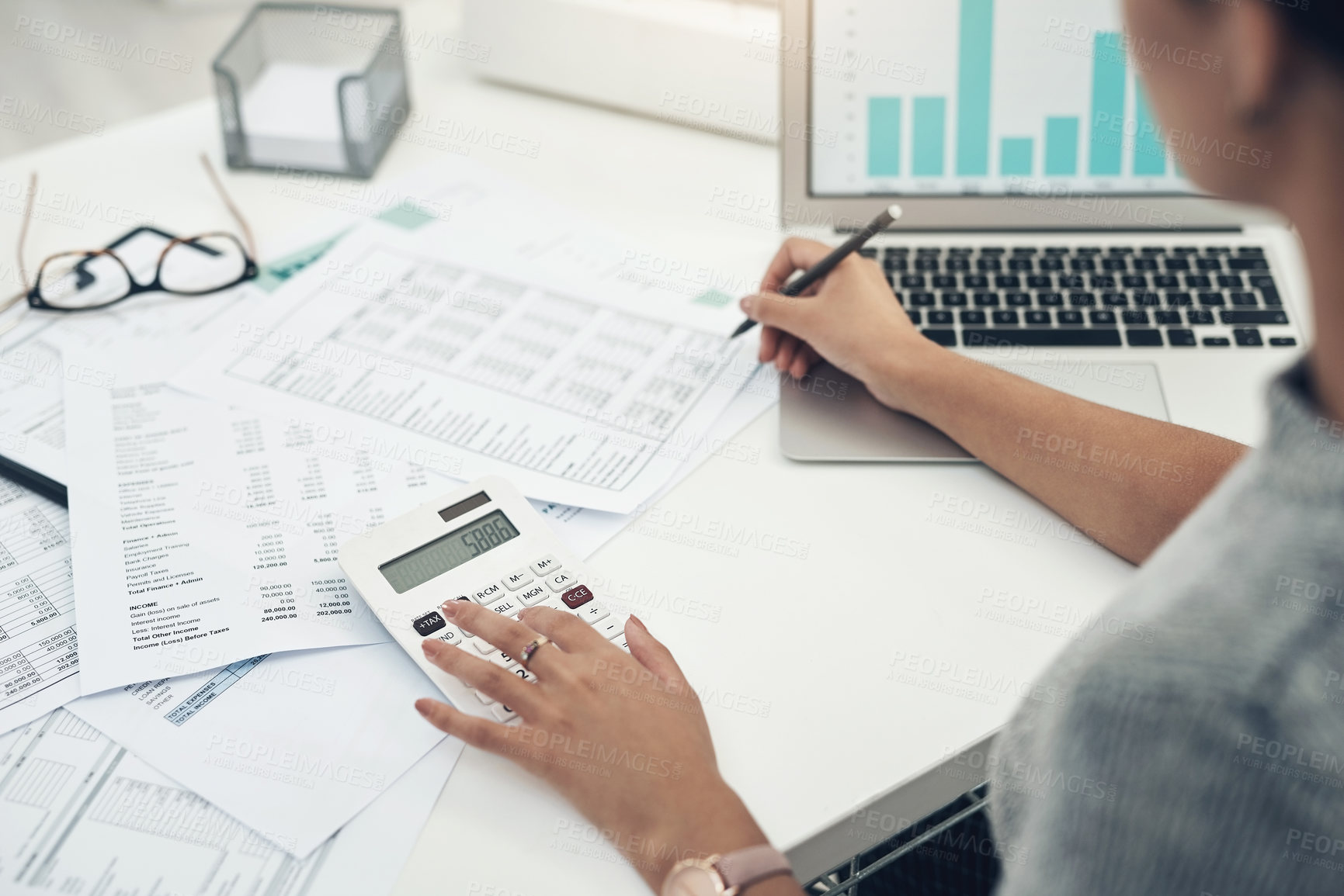 Buy stock photo Closeup shot of an unrecognisable businesswoman calculating finances in an office