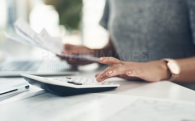 Buy stock photo Closeup shot of an unrecognisable businesswoman calculating finances in an office