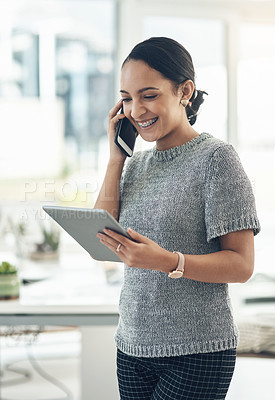 Buy stock photo Professional smiling businesswoman talking on phone call with client in modern office. Young design employee working on appointment booking on tablet standing in casual startup company