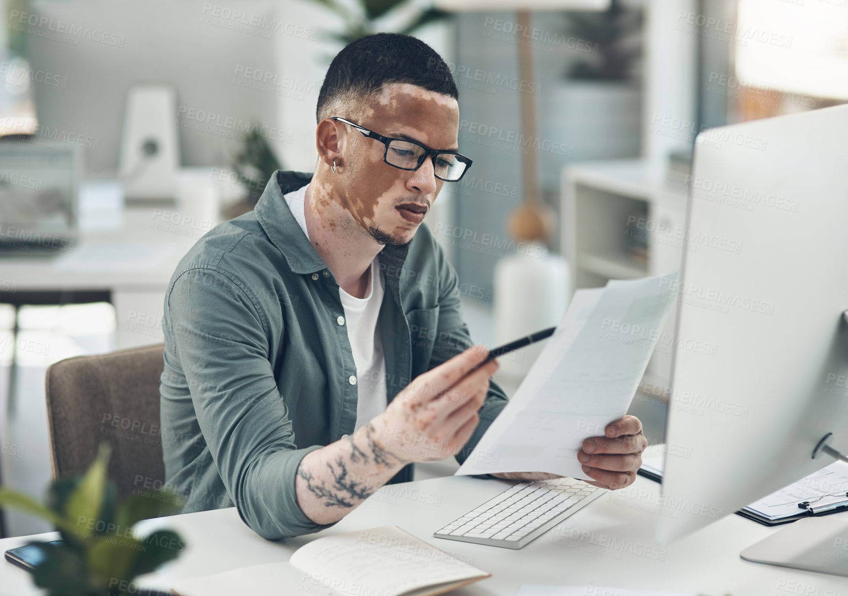 Buy stock photo Shot of a young business man working in a modern office