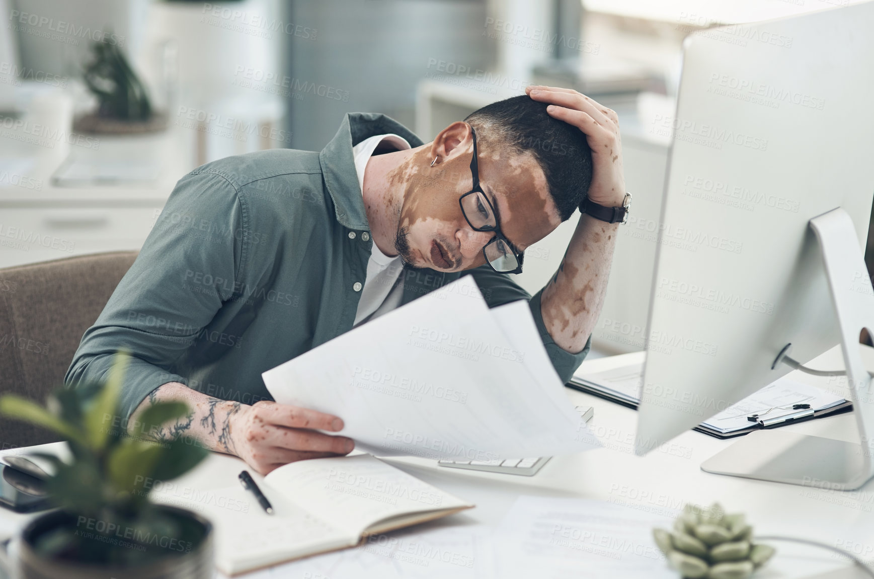 Buy stock photo Shot of a young business man working in a modern office