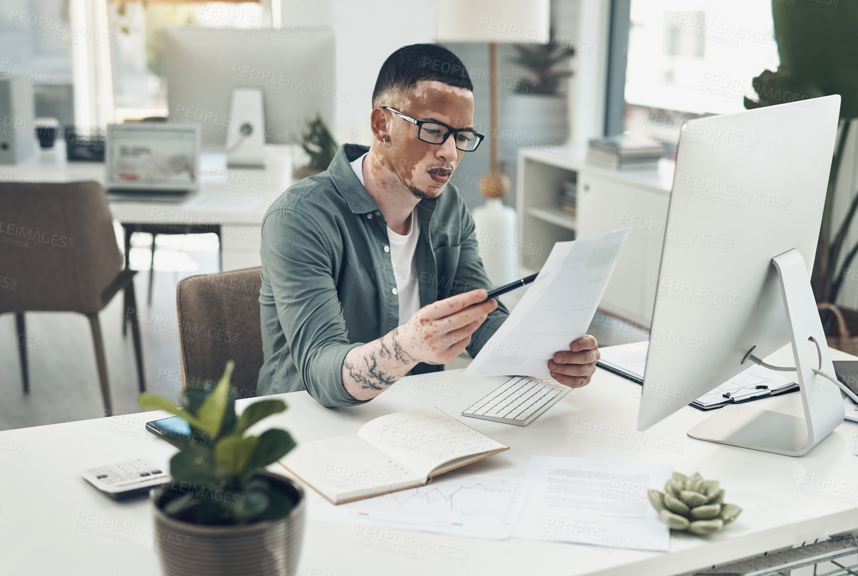 Buy stock photo Shot of a young business man working in a modern office