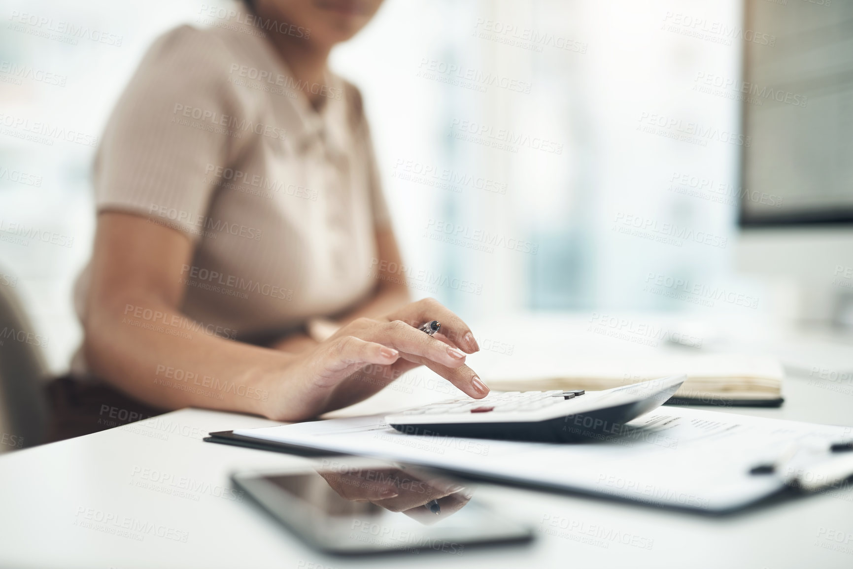 Buy stock photo Closeup shot of an unrecognisable businesswoman calculating finances in an office