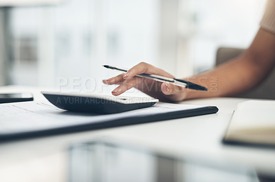 Buy stock photo Closeup shot of an unrecognisable businesswoman calculating finances in an office