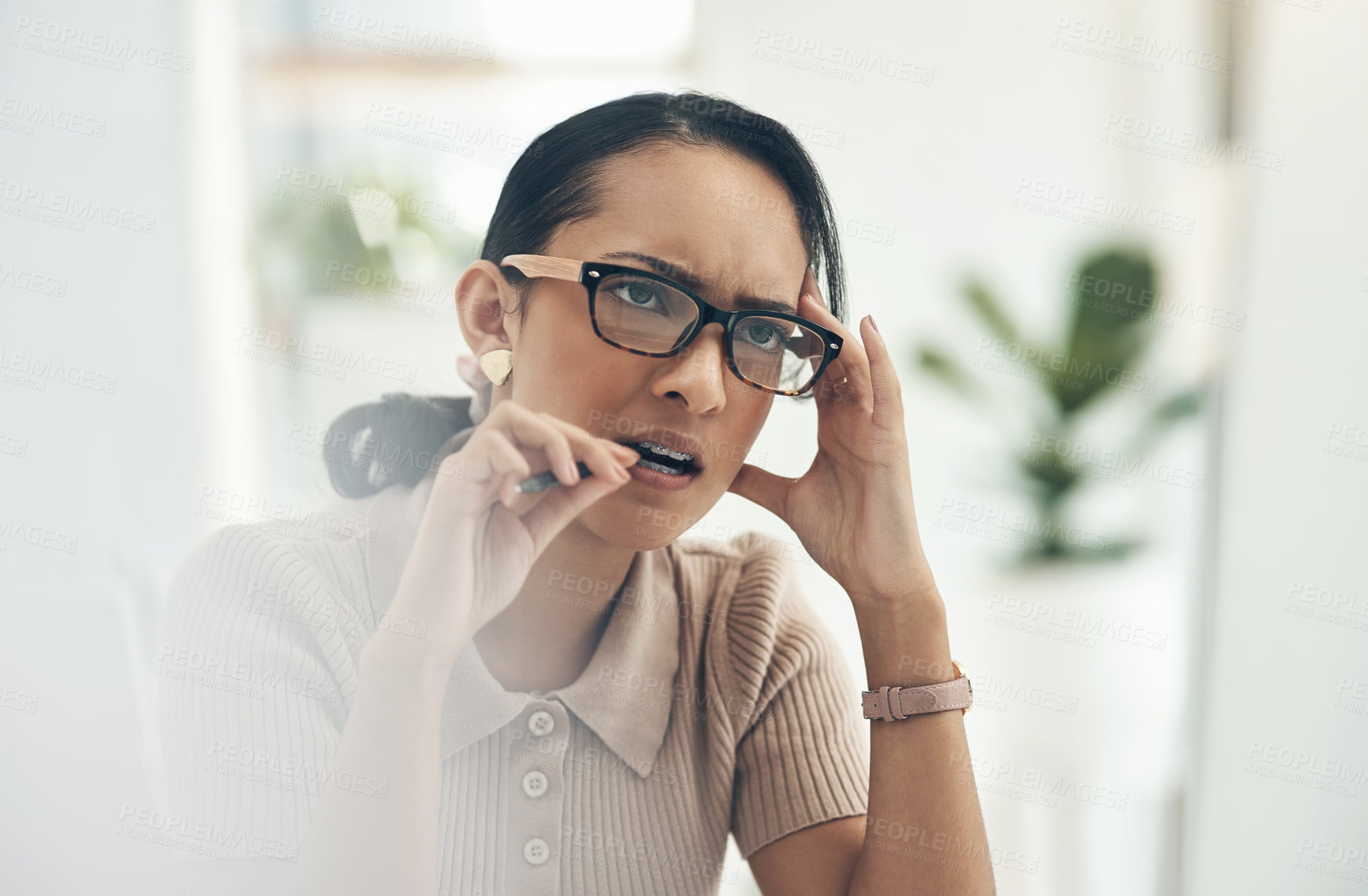 Buy stock photo Serious, thinking and confused business woman biting her pen, feeling nervous and trying to solve a problem. Female business professional struggling with mental fatigue while working in her office