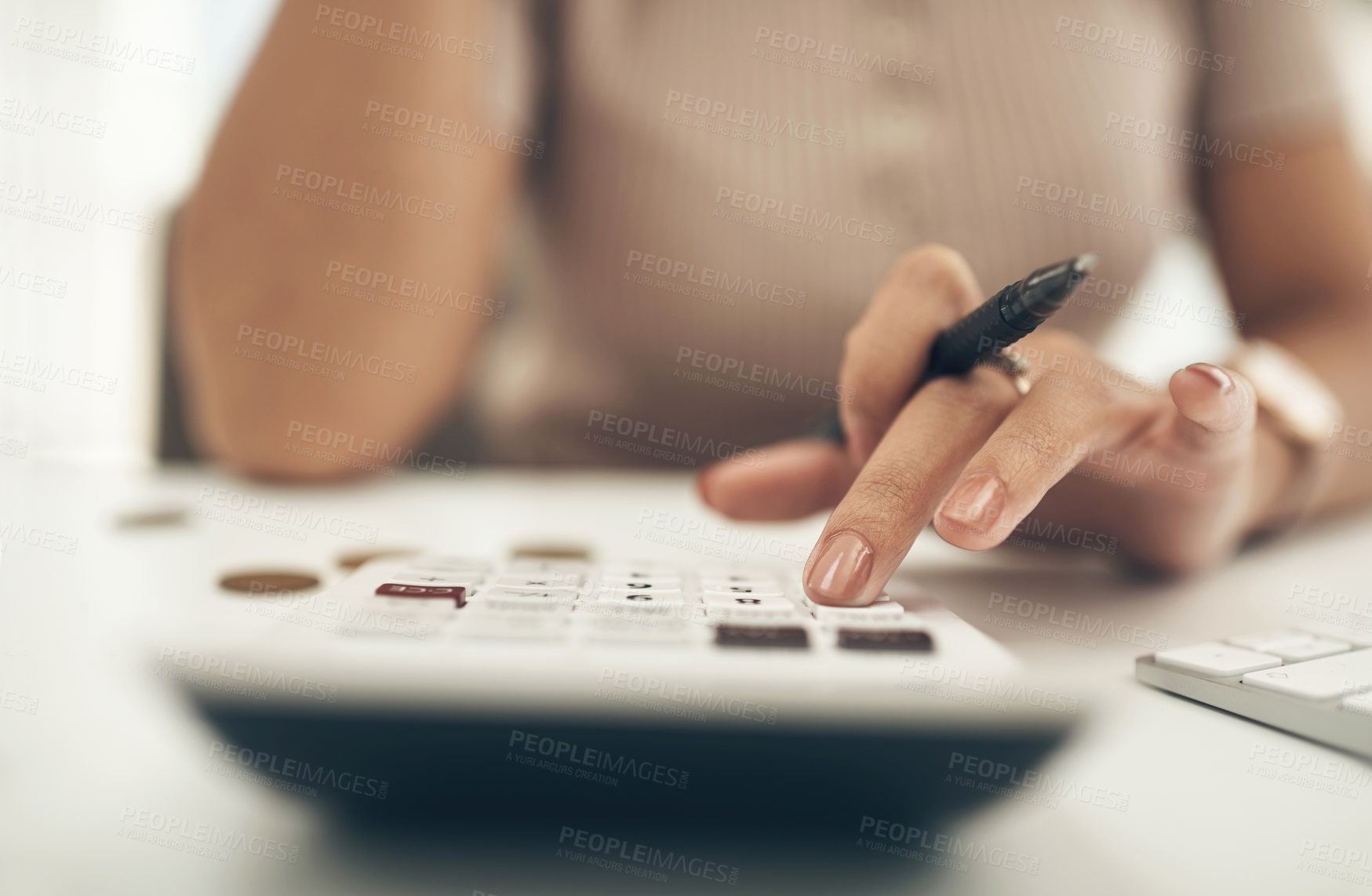 Buy stock photo Closeup shot of an unrecognisable businesswoman calculating finances in an office