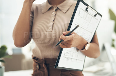 Buy stock photo Closeup shot of an unrecognisable businesswoman holding a clipboard and pen in an office