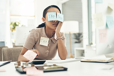Buy stock photo Shot of a young businesswoman covered in sticky notes while working on her taxes in an office