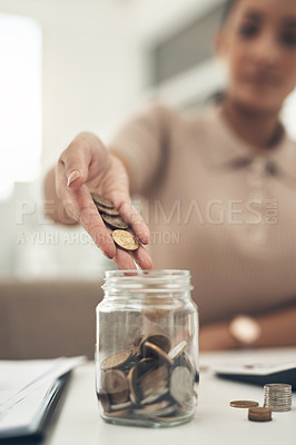 Buy stock photo Closeup shot of an unrecognisable businesswoman filling a glass jar with coins in an office