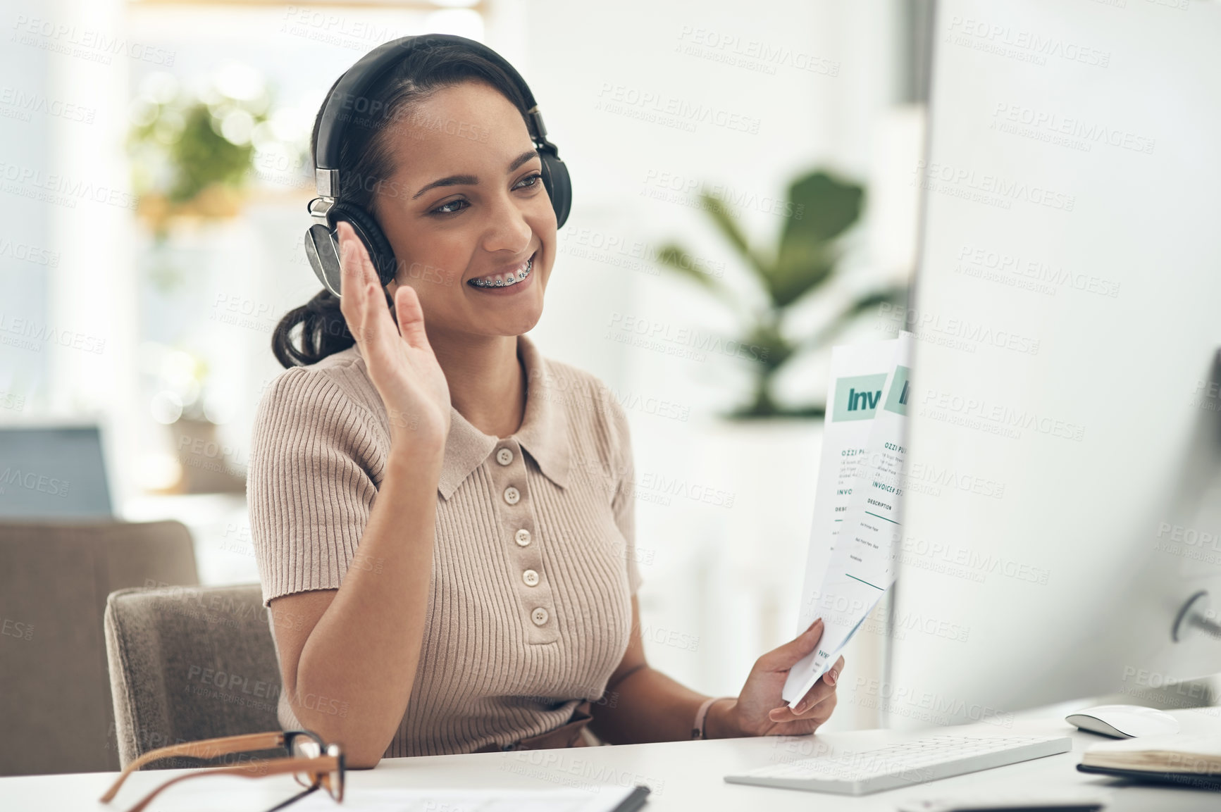 Buy stock photo Shot of a young businesswoman waving during a video call on a computer in an office