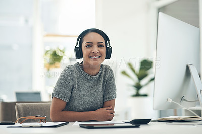 Buy stock photo Relaxed, satisfied businesswoman listening to music in headphones while sitting alone in an office. Female office worker enjoying a podcast or songs during a break in a corporate company 